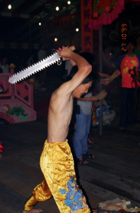 A tangki cutting himself with a jagged-tooth sword. Photo: Margaret Chan